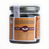 Jar of wild honey with a label on a white background