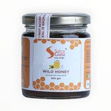 Jar of Satva Guna wild honey on a white background