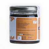 Jar of honey with label showing manufacturing details on a white background