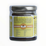 Jar of ginger honey with a label on a white background
